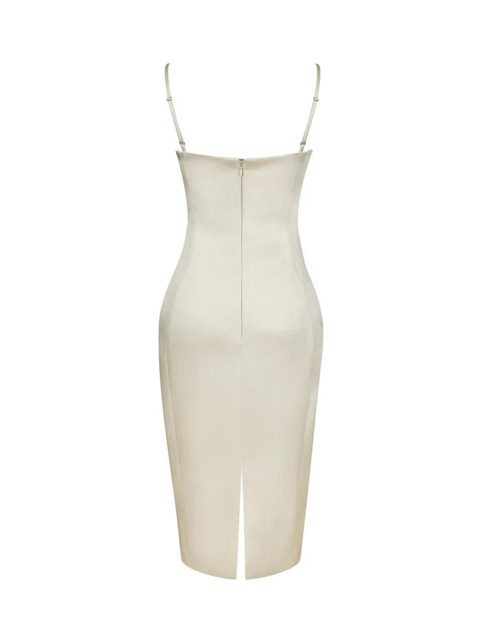 A woman modeling a fitted cream-colored midi dress with spaghetti straps and a ruched sweetheart neckline.