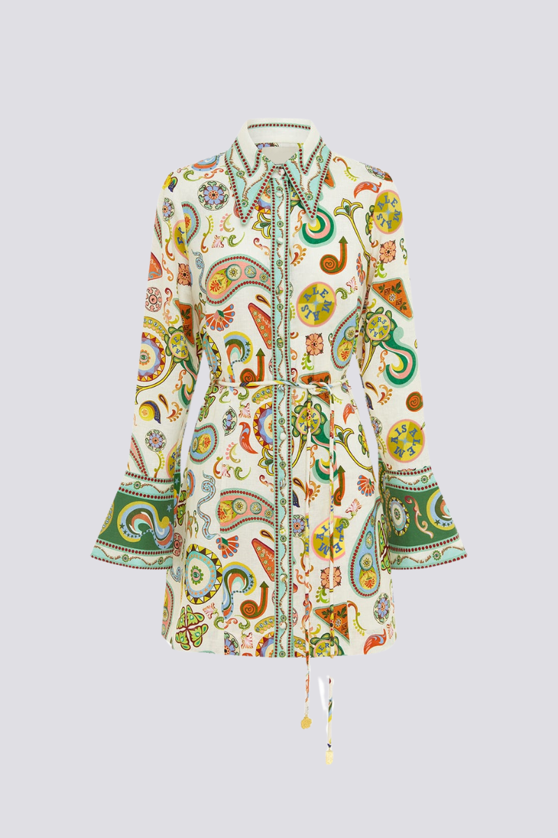 Multicolor - Full-length studio shot of a female model wearing a long-sleeved, collared mini shirt dress featuring a colourful paisley print, cinched at the waist with a tie-belt.
