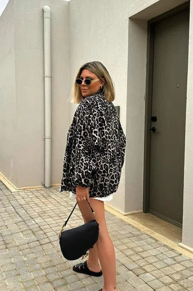 Leopard Print - Women's oversized bomber jacket featuring a bold all-over leopard print, styled open with a silver-tone front zipper and voluminous sleeves.