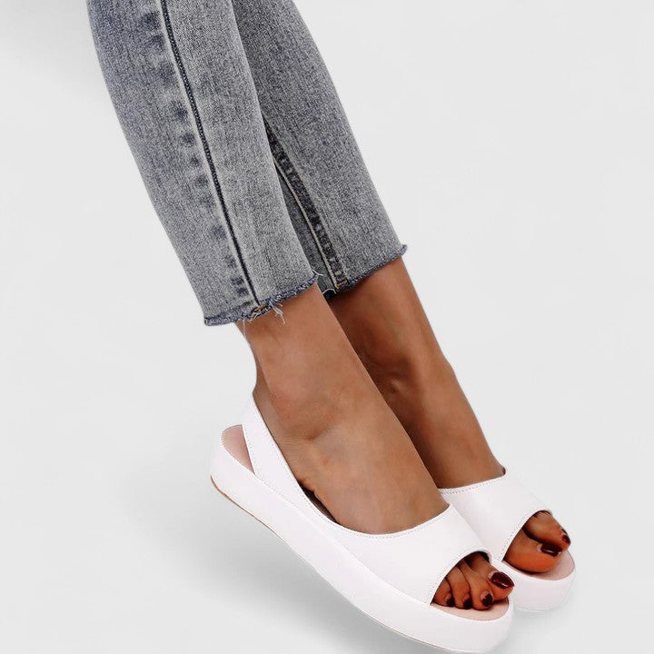 White - Faux-leather platform sandals featuring a wide front strap, open toe, and a continuous slingback strap on a thick cushioned sole.