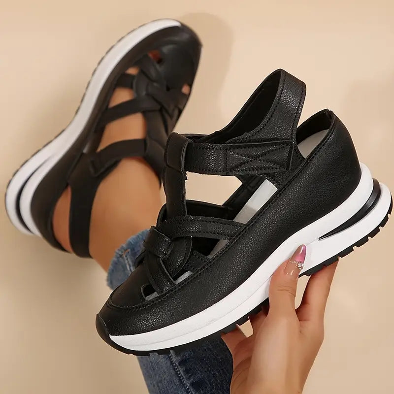 Black - Women's faux-leather orthopedic platform sandals featuring a woven cut-out upper design, adjustable heel strap, and thick cushioned sole, modeled on feet.