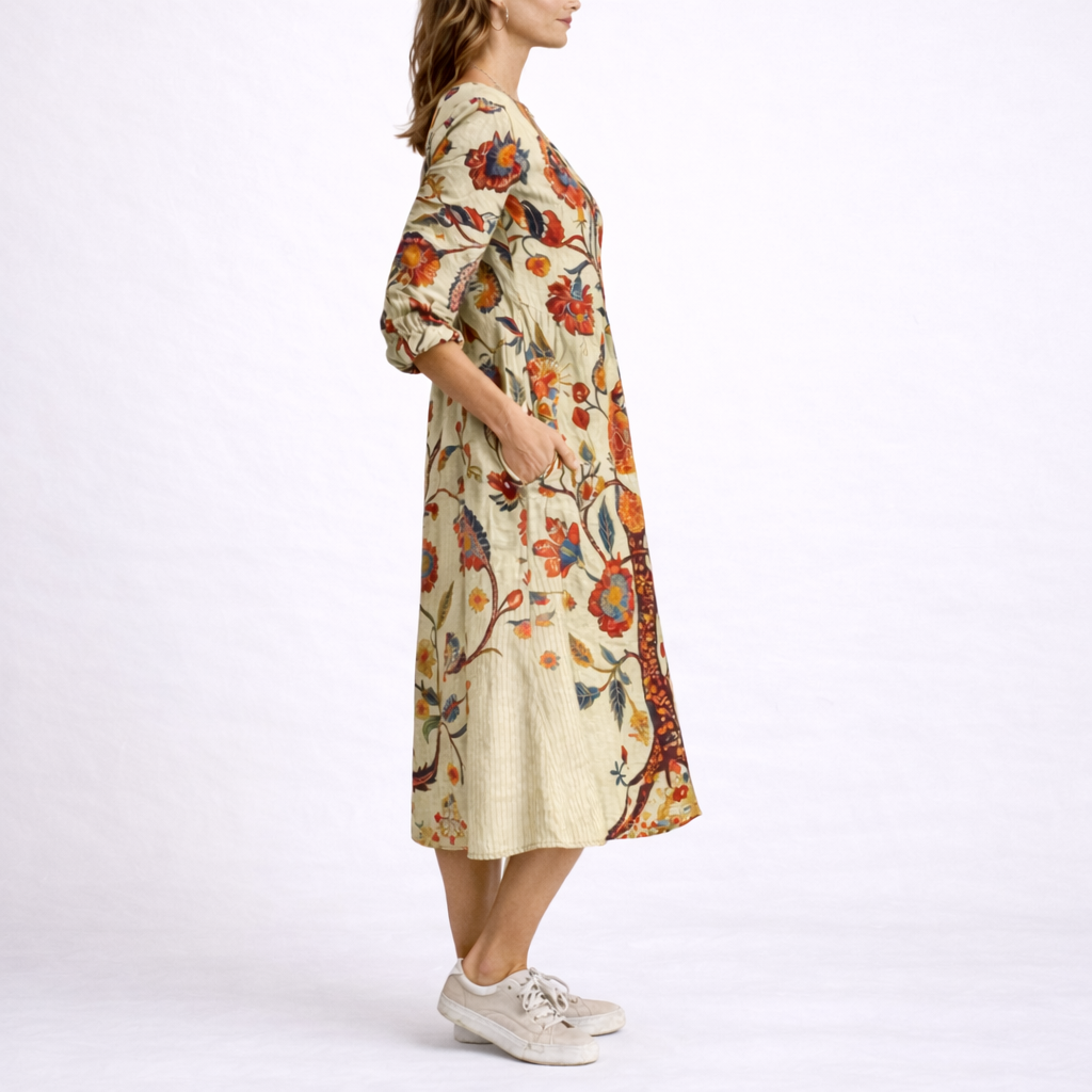 Beige - Model wearing a relaxed fit floral print V-neck midi dress with three-quarter sleeves, holding a woven basket filled with flowers.