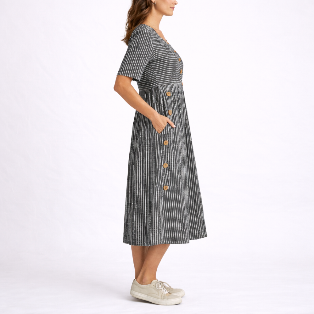 Gray - Model wearing a striped short-sleeve midi dress with asymmetric button detailing and side pockets against a plain background