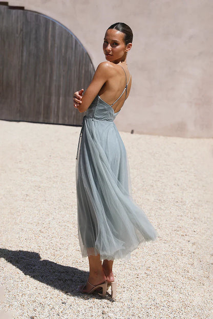 Woman in dusty blue tulle midi dress