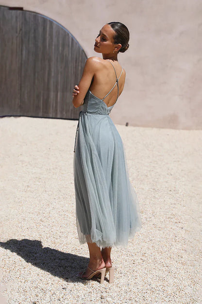Woman in dusty blue tulle midi dress