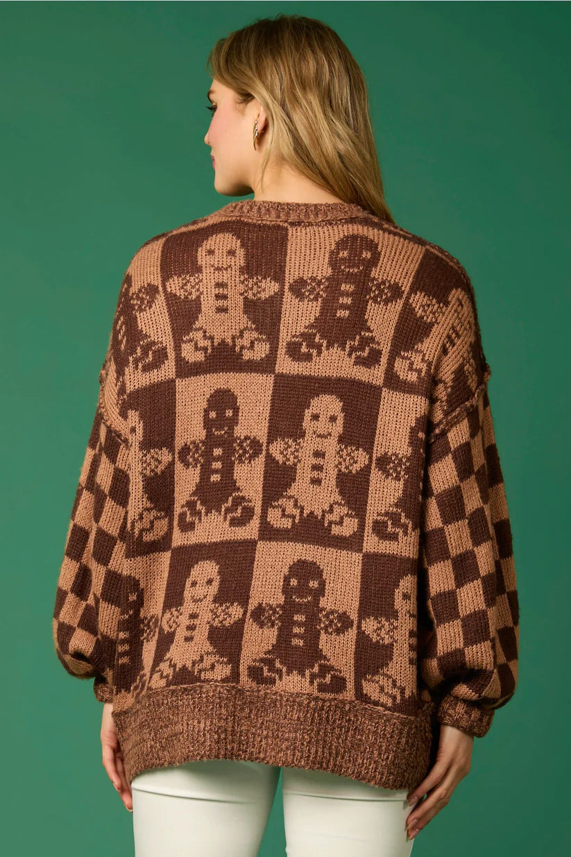 Brown - Women's oversized knit jumper featuring a festive red and white candy cane and checkerboard pattern, styled with drop shoulders and a crew neckline.