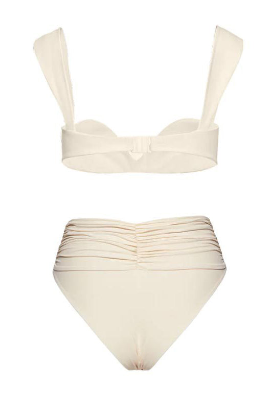 Black - A woman models a structured, off-white two-piece bikini featuring a bandeau top with wide straps and high-waisted, high-cut bottoms adorned with a large, 3D rose appliqué at the waist.