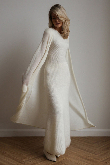 White - A woman modeling a fuzzy white ribbed knit maxi dress paired with a matching longline duster cardigan, showcasing a sleek and elegant winter silhouette.
