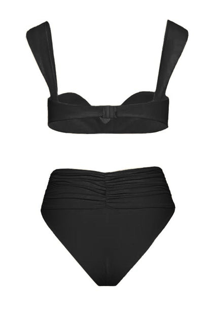Black - A woman models a structured, off-white two-piece bikini featuring a bandeau top with wide straps and high-waisted, high-cut bottoms adorned with a large, 3D rose appliqué at the waist.