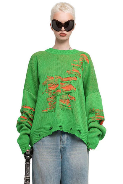 Green - Model wearing a women's oversized black knit jumper featuring heavy distressed laddering and cut-outs, styled with a white mini skirt.