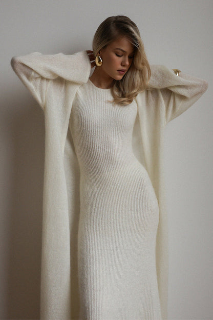 White - A woman modeling a fuzzy white ribbed knit maxi dress paired with a matching longline duster cardigan, showcasing a sleek and elegant winter silhouette.