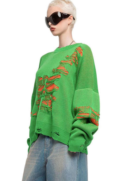 Green - Model wearing a women's oversized black knit jumper featuring heavy distressed laddering and cut-outs, styled with a white mini skirt.