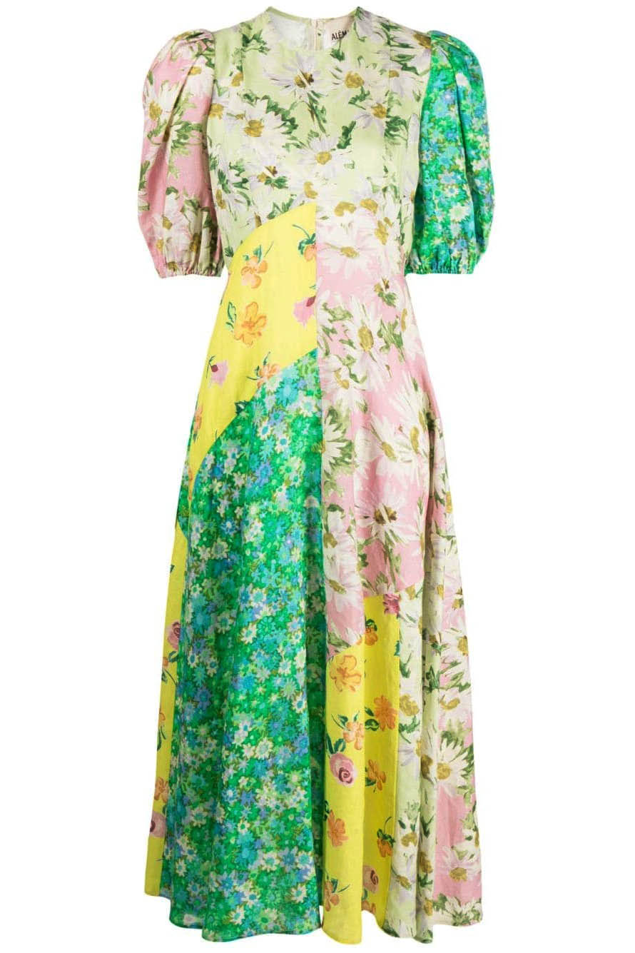 A woman models a short-sleeve, crewneck midi dress with a white background and a colorful, illustrative print of marine life including jellyfish, coral, and seashells.
