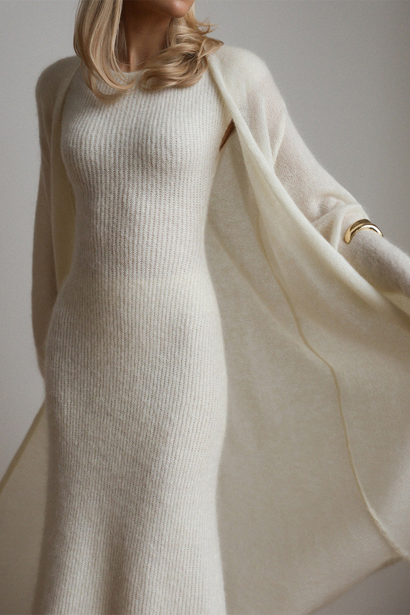 White - A woman modeling a fuzzy white ribbed knit maxi dress paired with a matching longline duster cardigan, showcasing a sleek and elegant winter silhouette.