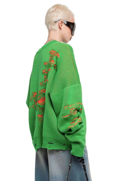 Green - Model wearing a women's oversized black knit jumper featuring heavy distressed laddering and cut-outs, styled with a white mini skirt.
