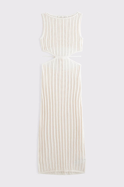 White - A woman models a sleeveless, cream-colored open-knit maxi dress with a high neckline and cutouts at the waist, shown against a plain white background.