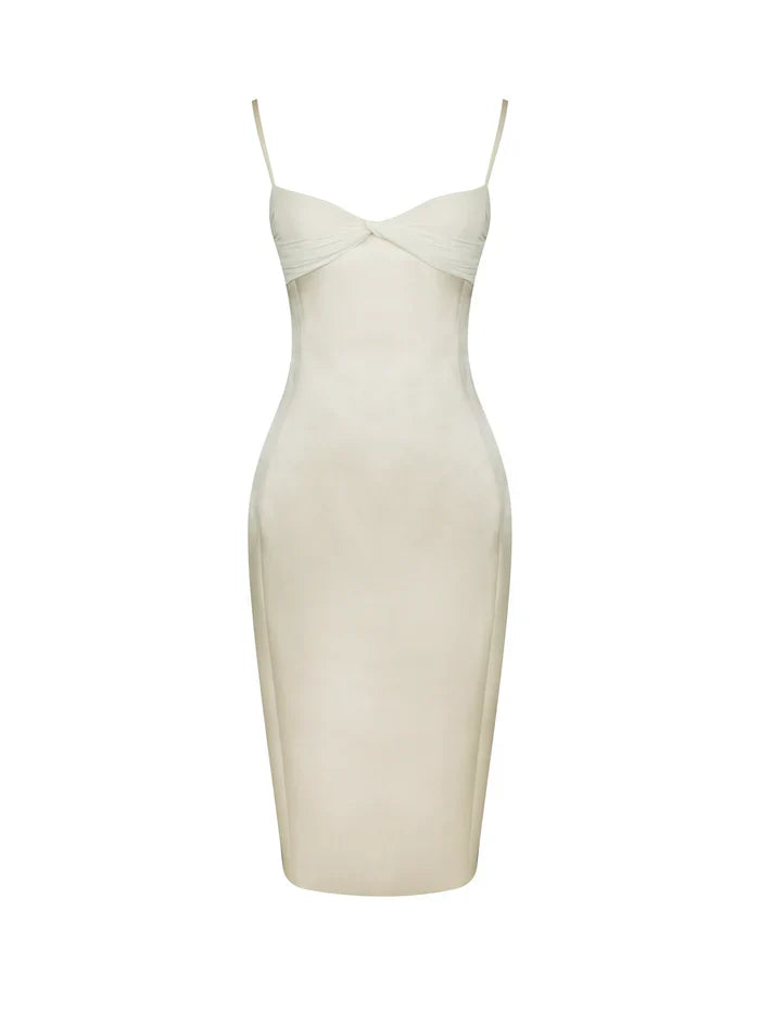 A woman modeling a fitted cream-colored midi dress with spaghetti straps and a ruched sweetheart neckline.