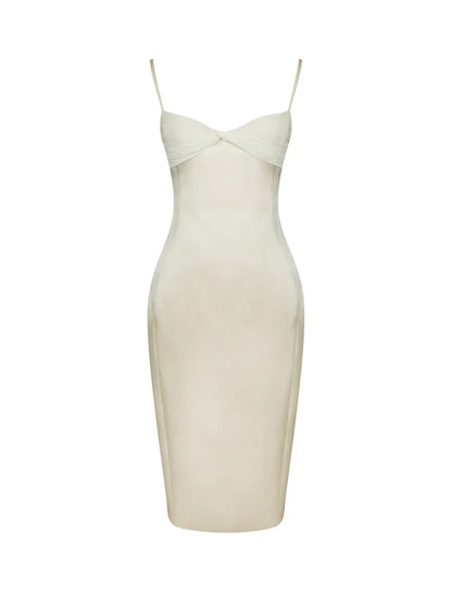 A woman modeling a fitted cream-colored midi dress with spaghetti straps and a ruched sweetheart neckline.