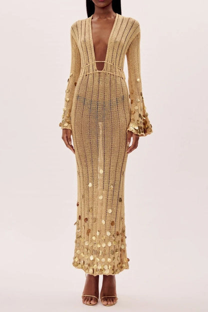 Yellow - Full-length view of a model wearing a long-sleeve, gold open-knit maxi dress with a plunging V-neckline, flared cuffs, and large gold sequin embellishments.