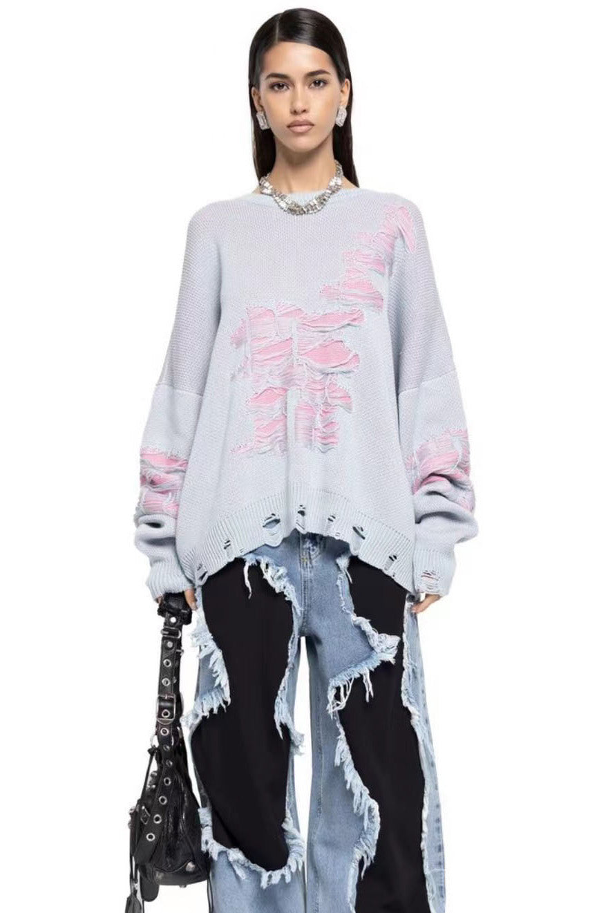 Green - Model wearing a women's oversized black knit jumper featuring heavy distressed laddering and cut-outs, styled with a white mini skirt.