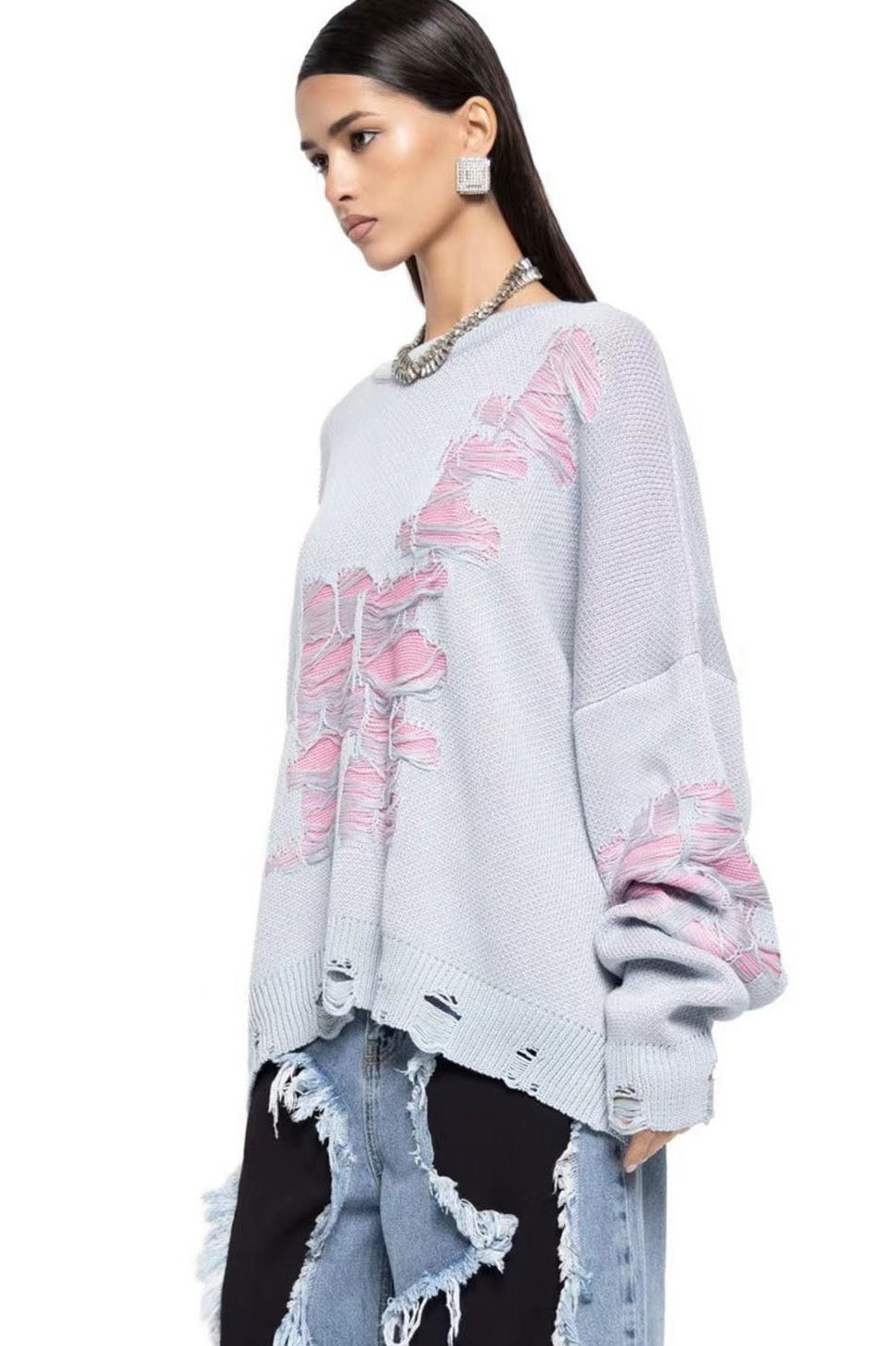 Green - Model wearing a women's oversized black knit jumper featuring heavy distressed laddering and cut-outs, styled with a white mini skirt.