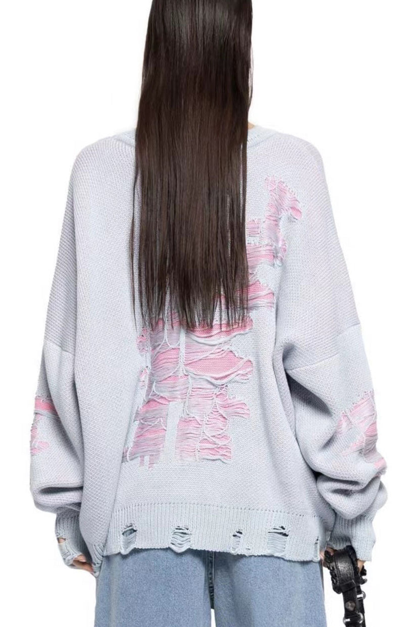 Green - Model wearing a women's oversized black knit jumper featuring heavy distressed laddering and cut-outs, styled with a white mini skirt.