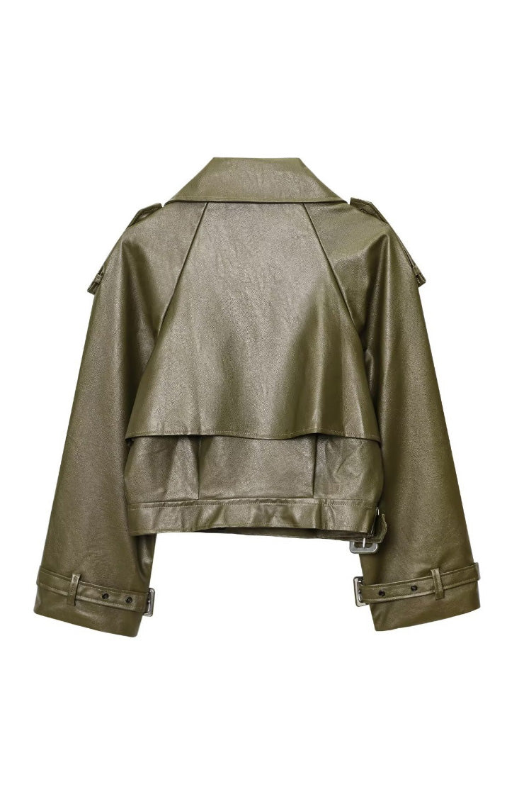 Green - A woman wearing a burgundy oversized faux leather jacket with wide lapels, belted cuffs, and voluminous sleeves, styled over a black turtleneck in a city setting.