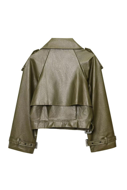 Green - A woman wearing a burgundy oversized faux leather jacket with wide lapels, belted cuffs, and voluminous sleeves, styled over a black turtleneck in a city setting.
