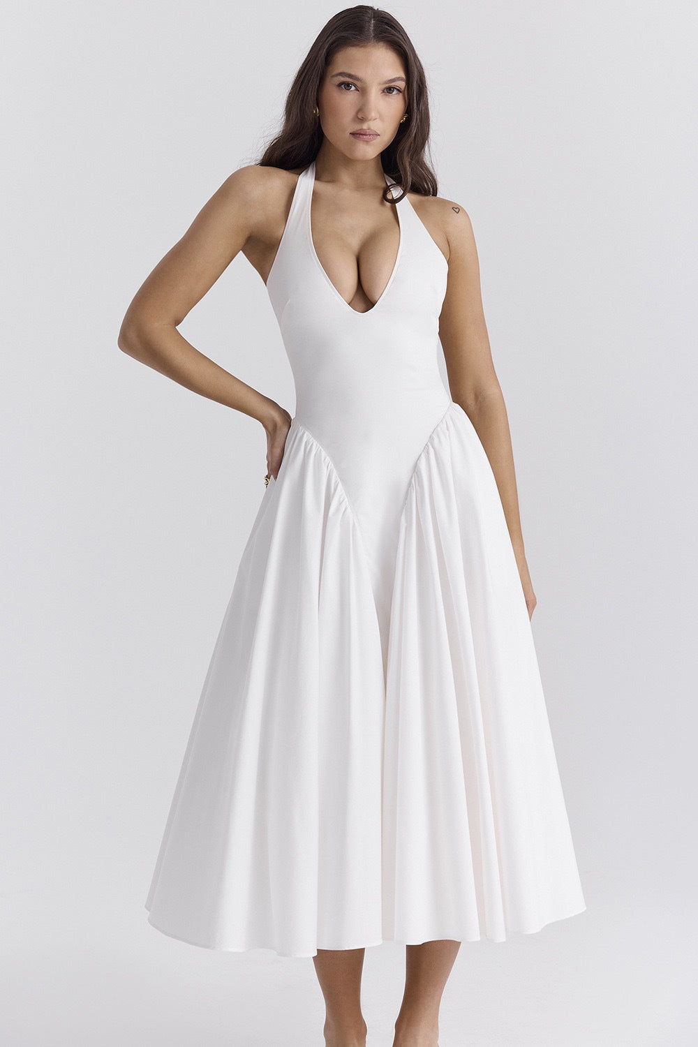 White - A woman models a white sleeveless midi dress with a deep V-neck halter top, a fitted bodice, and a full, gathered A-line skirt, against a plain white background.