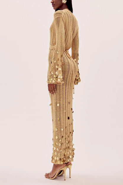 Yellow - Full-length view of a model wearing a long-sleeve, gold open-knit maxi dress with a plunging V-neckline, flared cuffs, and large gold sequin embellishments.