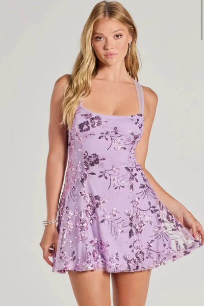 Purple - A woman stands in a full-length pose wearing a lavender, sleeveless, A-line mini dress with a square neckline, featuring all-over tonal purple sequin floral embroidery, against a plain studio background.