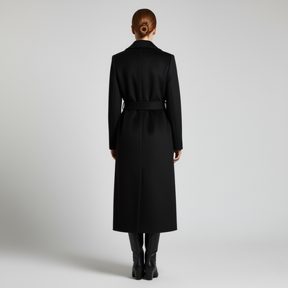 Schwarz - Women's elegant black tailored maxi wrap coat featuring wide notch lapels and a self-tie waist belt, worn by a model over black leather boots against a light grey background.