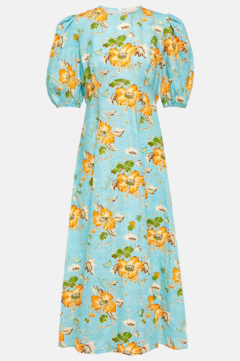A woman models a short-sleeve, crewneck midi dress with a white background and a colorful, illustrative print of marine life including jellyfish, coral, and seashells.