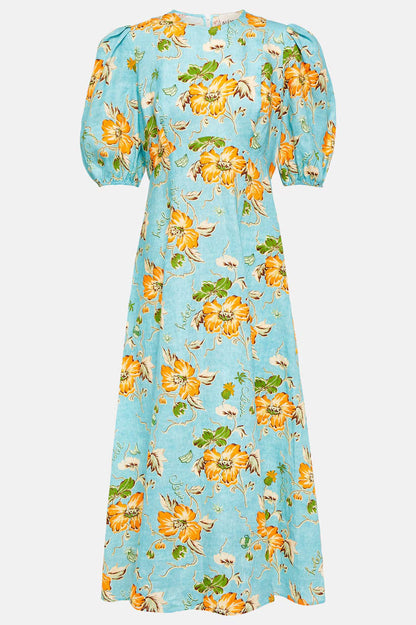 A woman models a short-sleeve, crewneck midi dress with a white background and a colorful, illustrative print of marine life including jellyfish, coral, and seashells.