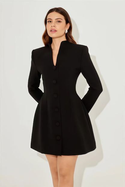 Black - A woman models a long-sleeve, black mini blazer dress with a high split funnel neck, structured shoulders, and a single-breasted button front against a plain white background.