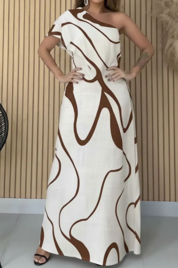Woman in cream and black abstract print one-shoulder maxi dress