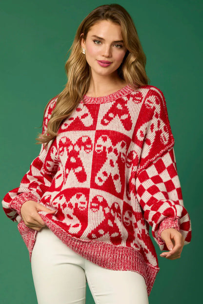 Red - Women's oversized knit jumper featuring a festive red and white candy cane and checkerboard pattern, styled with drop shoulders and a crew neckline.