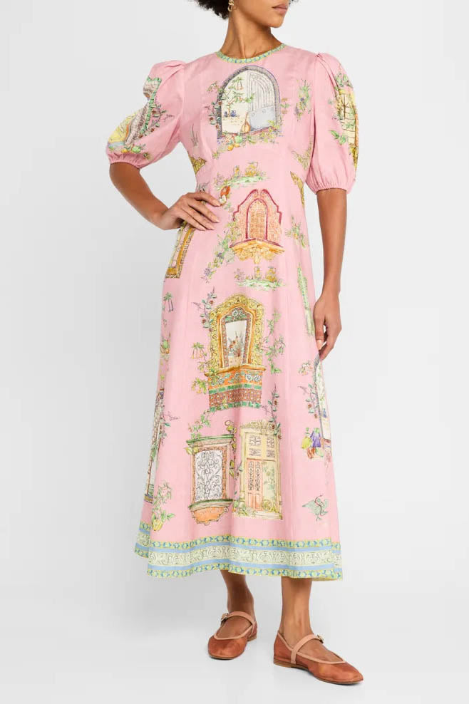 A woman models a short-sleeve, crewneck midi dress with a white background and a colorful, illustrative print of marine life including jellyfish, coral, and seashells.