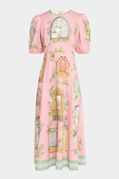 A woman models a short-sleeve, crewneck midi dress with a white background and a colorful, illustrative print of marine life including jellyfish, coral, and seashells.