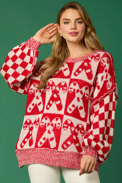 Red - Women's oversized knit jumper featuring a festive red and white candy cane and checkerboard pattern, styled with drop shoulders and a crew neckline.