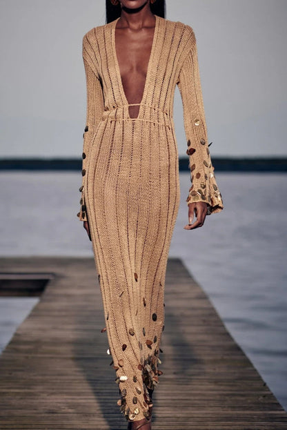 Yellow - Full-length view of a model wearing a long-sleeve, gold open-knit maxi dress with a plunging V-neckline, flared cuffs, and large gold sequin embellishments.