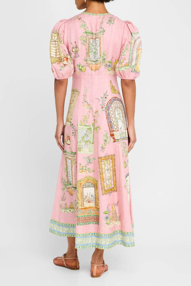 A woman models a short-sleeve, crewneck midi dress with a white background and a colorful, illustrative print of marine life including jellyfish, coral, and seashells.
