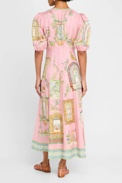 A woman models a short-sleeve, crewneck midi dress with a white background and a colorful, illustrative print of marine life including jellyfish, coral, and seashells.