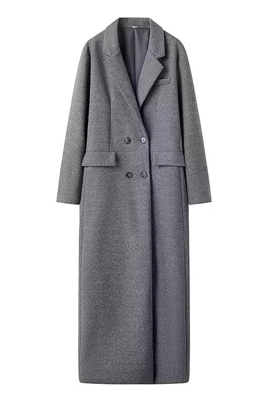 Grey - A woman wearing a long, oversized grey double-breasted maxi coat with wide lapels and flap pockets, styled for winter.