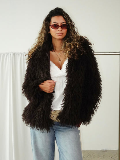 L/XL - Women's cropped shaggy faux fur jacket in a voluminous white texture, styled open over a white crop top and light wash denim jeans.
