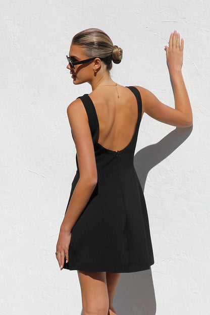 Woman in black crepe A-line mini dress