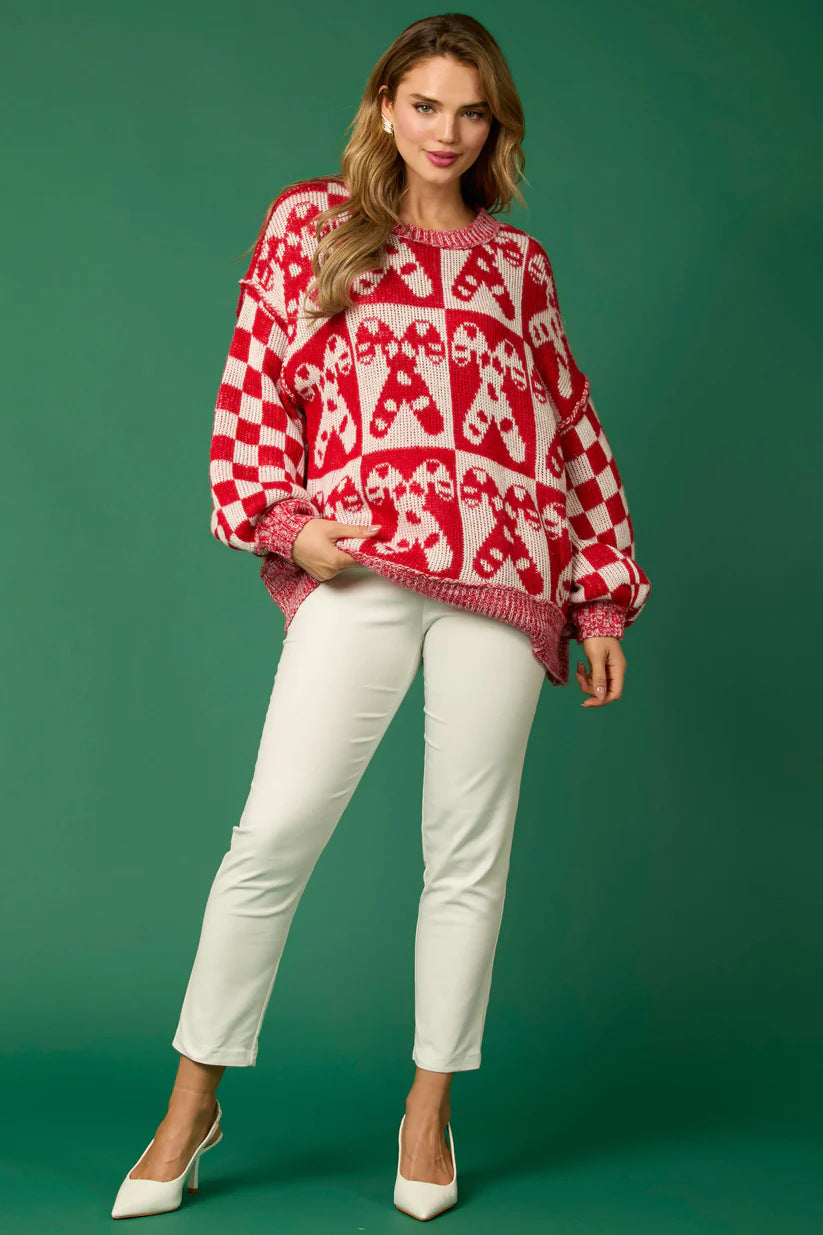 Red - Women's oversized knit jumper featuring a festive red and white candy cane and checkerboard pattern, styled with drop shoulders and a crew neckline.