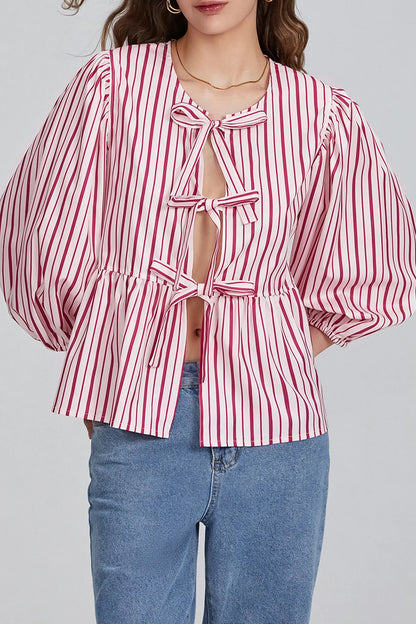Woman wearing white cotton tie-front peplum blouse and jeans