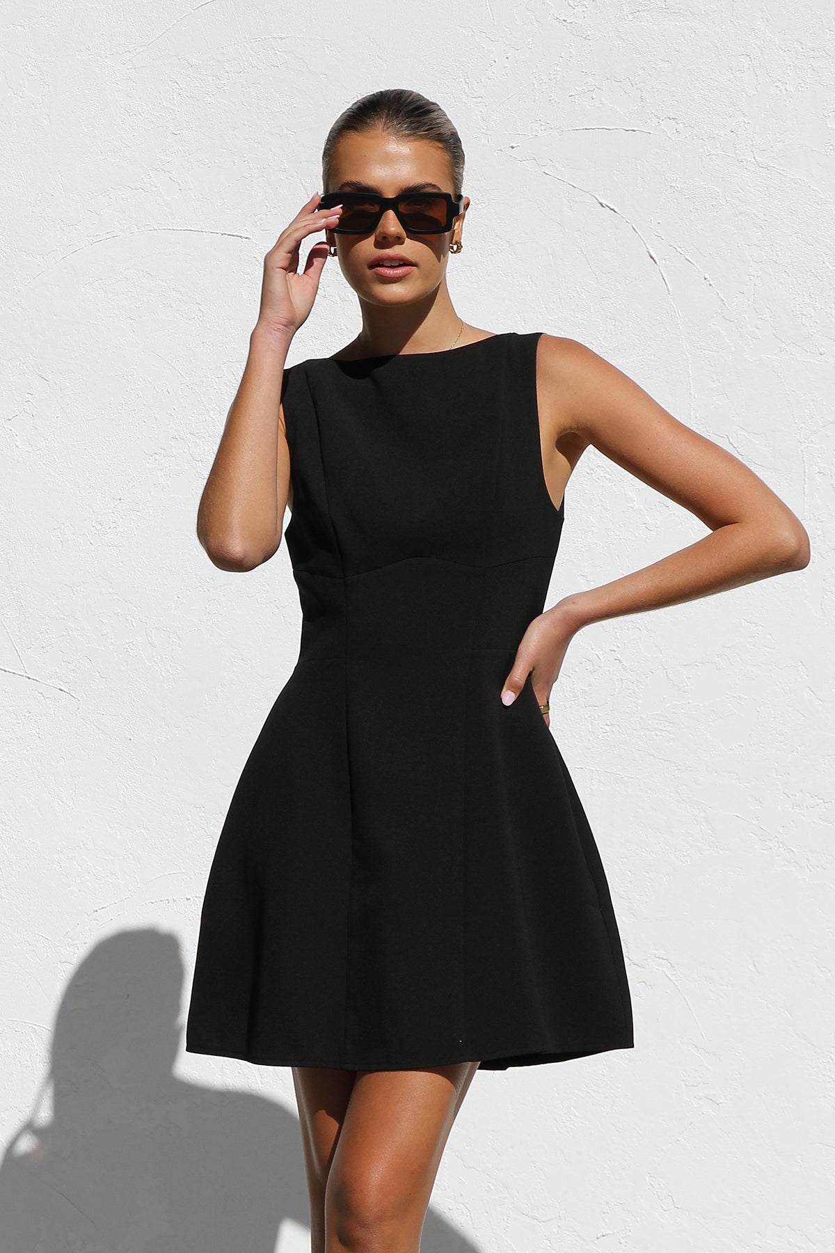 Woman in black crepe A-line mini dress