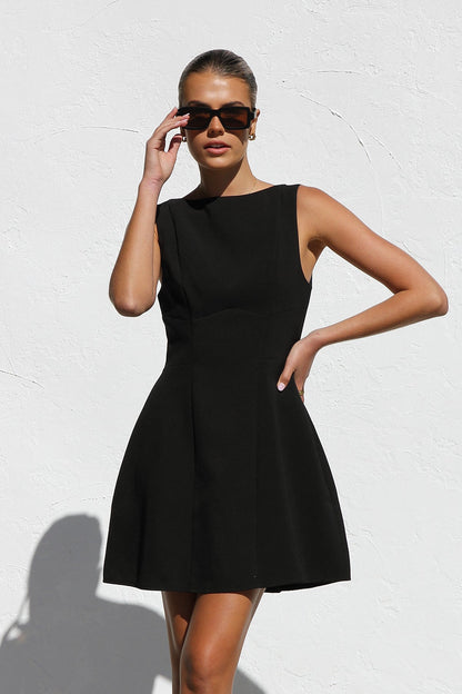 Woman in black crepe A-line mini dress